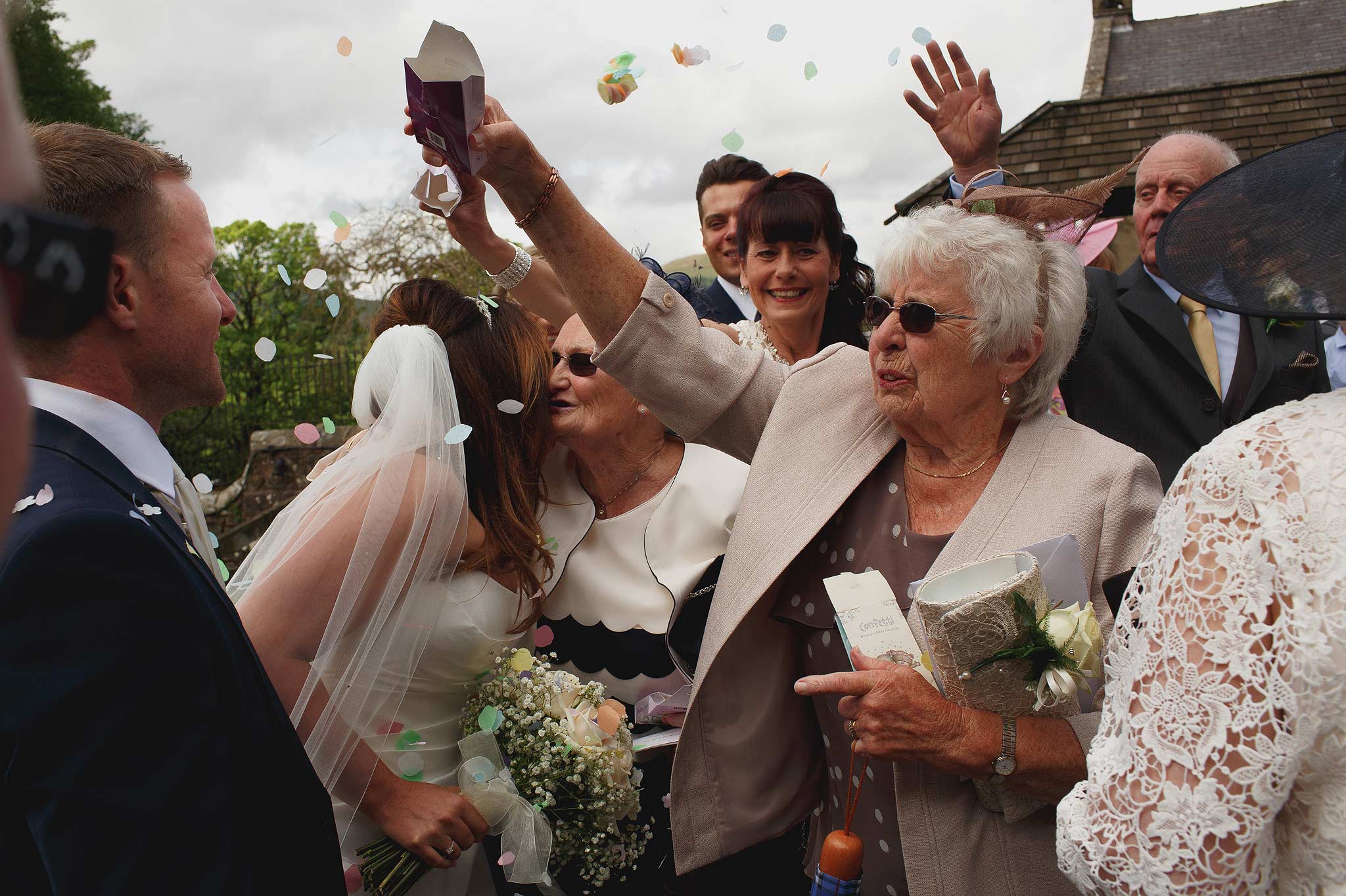 Confetti being thrown at a wedding at the inn at whitewell
