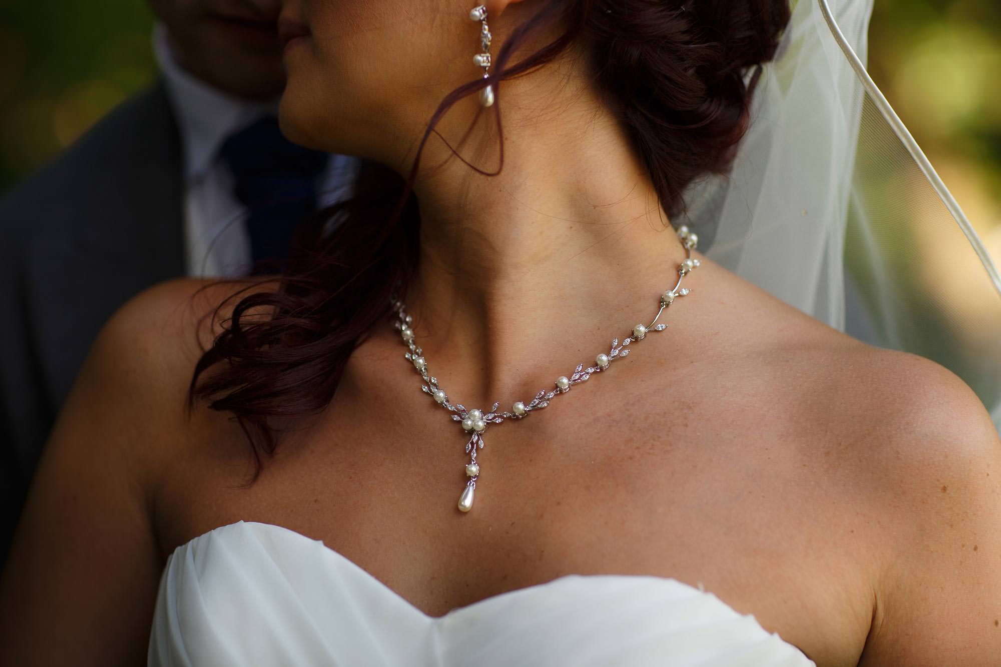 Close up detail of brides necklace at Arley Hall Wedding