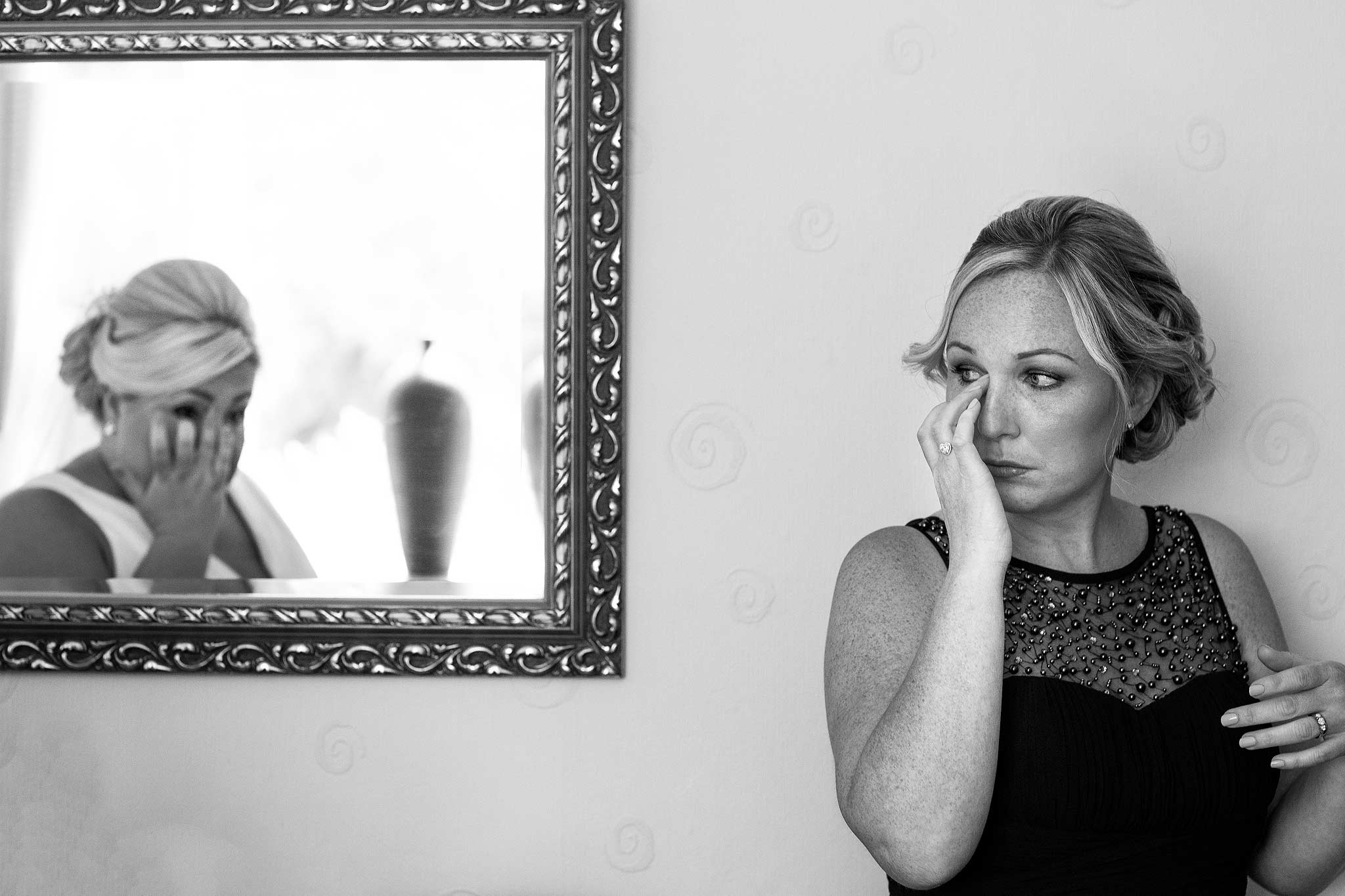 Reflection in a mirror or bridesmaid and bride both crying 