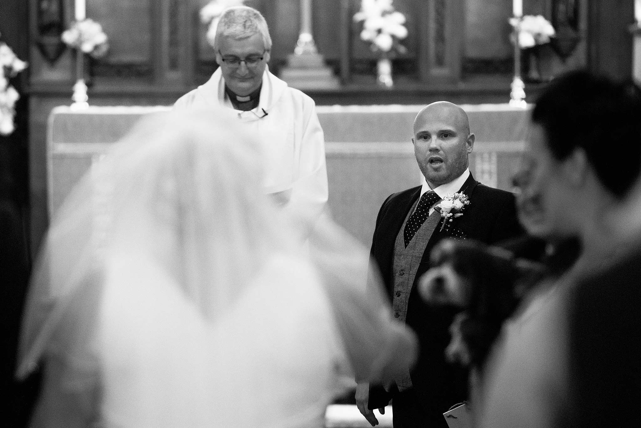 Grooms shocked face as the bride walks down the aisle 