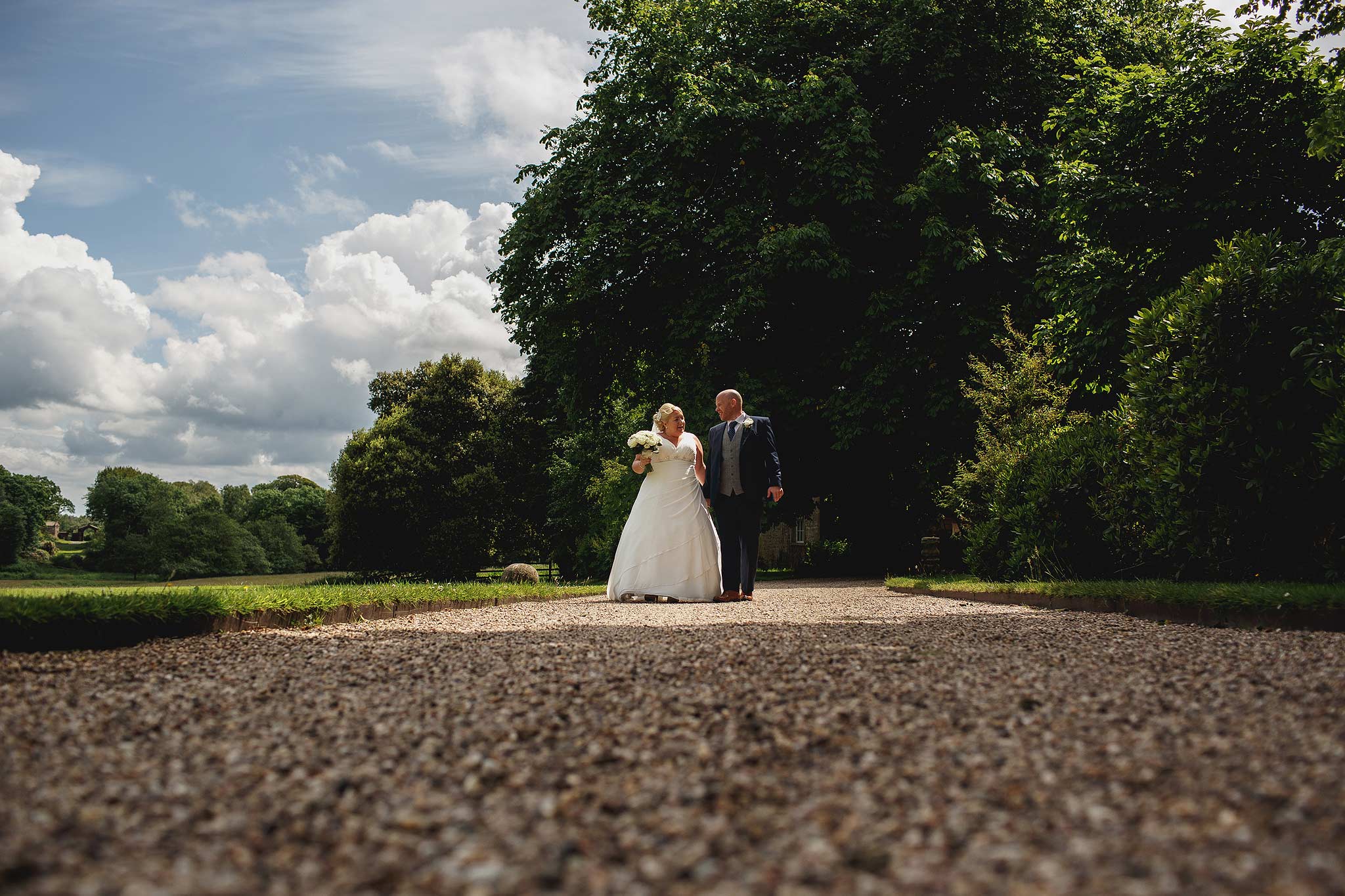 Bride and groom walking outside Browsholme Hall