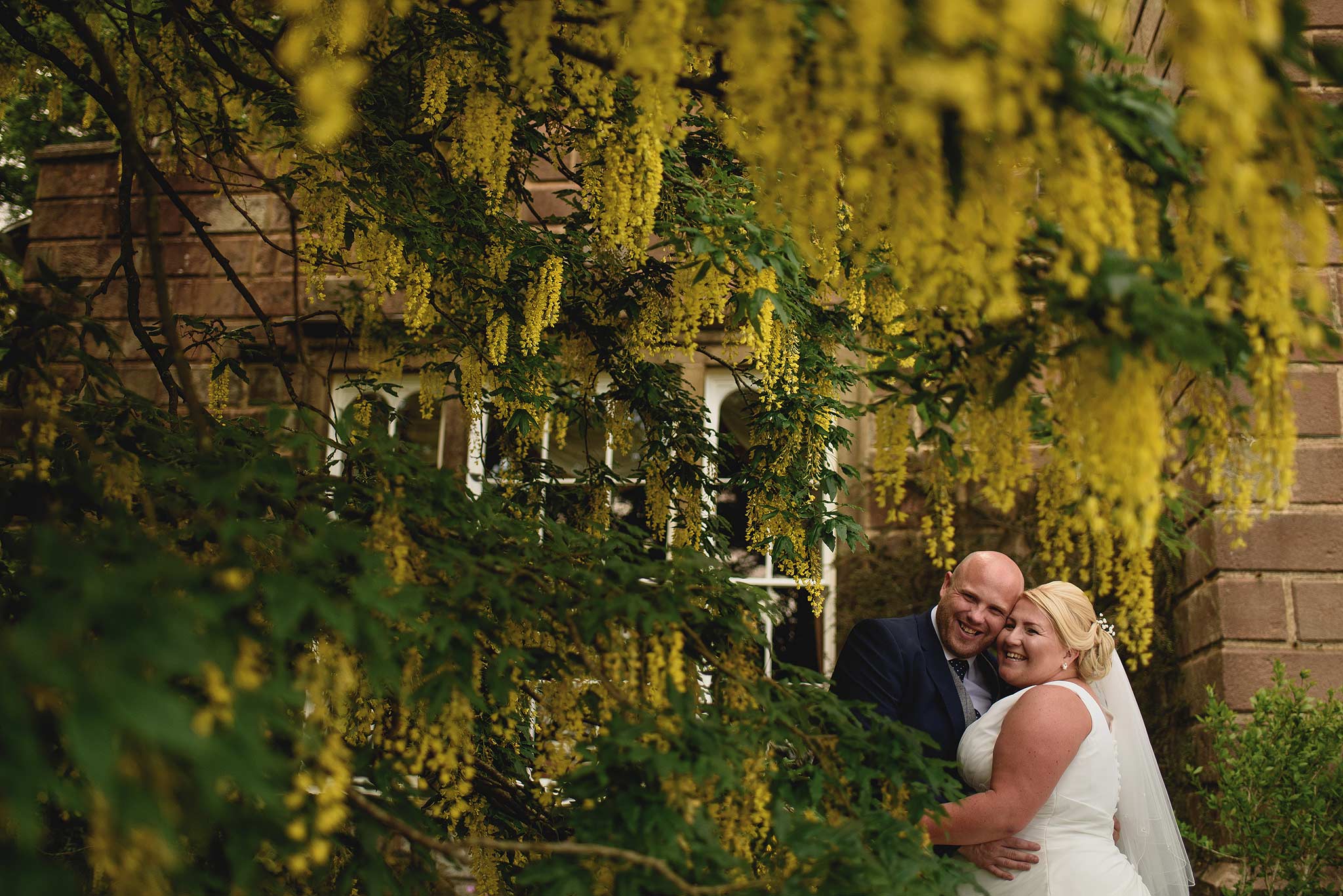 Bride and Groom under a yellow tree at Browsholme Hall