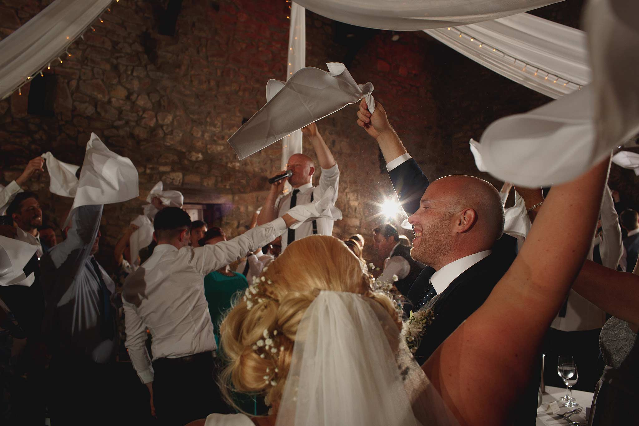 Wedding guests all swinging napkins at Browsholme Hall