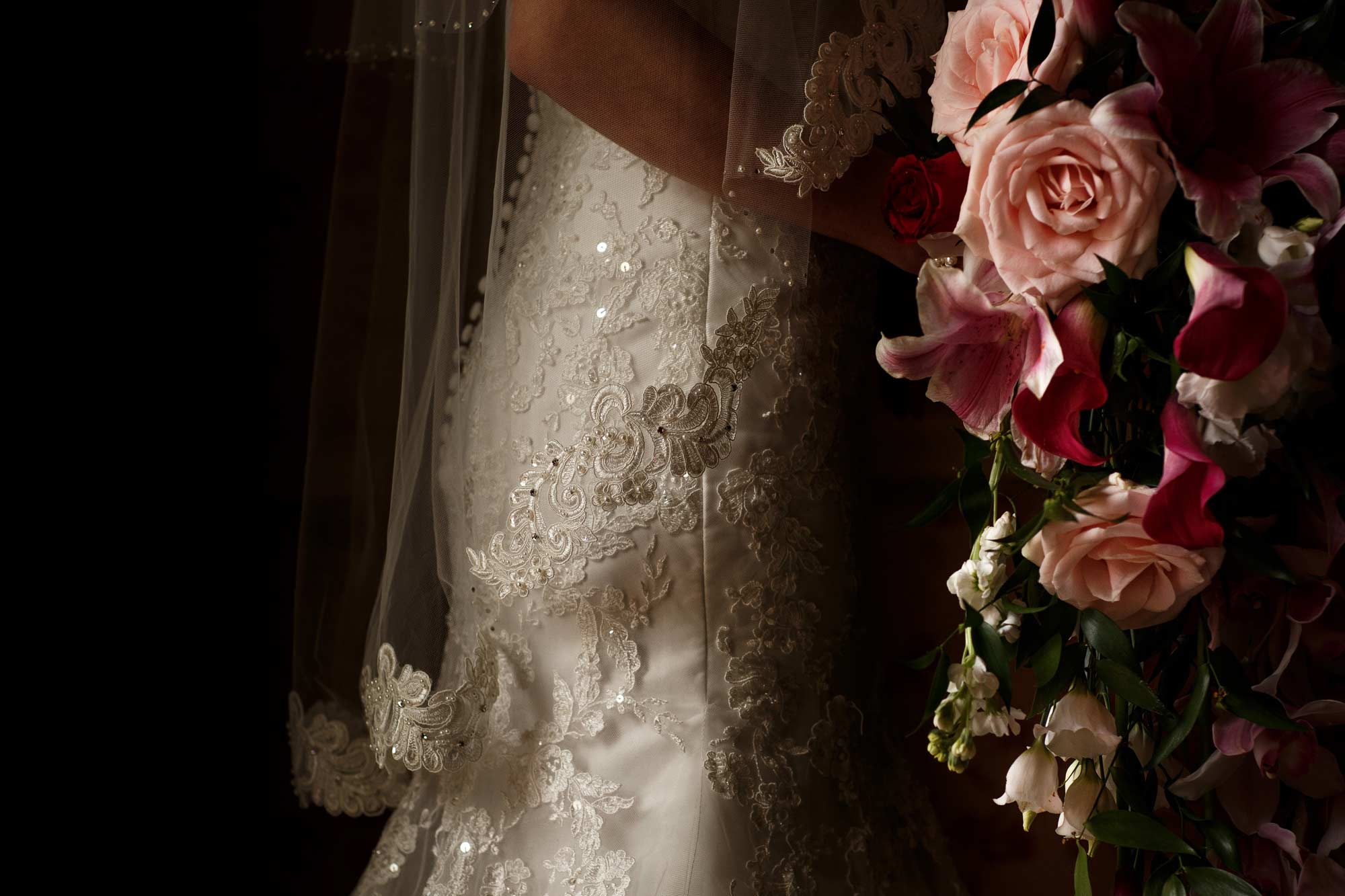 fine art portrait of the brides veil and flowers as she is about to walk into her ceremony