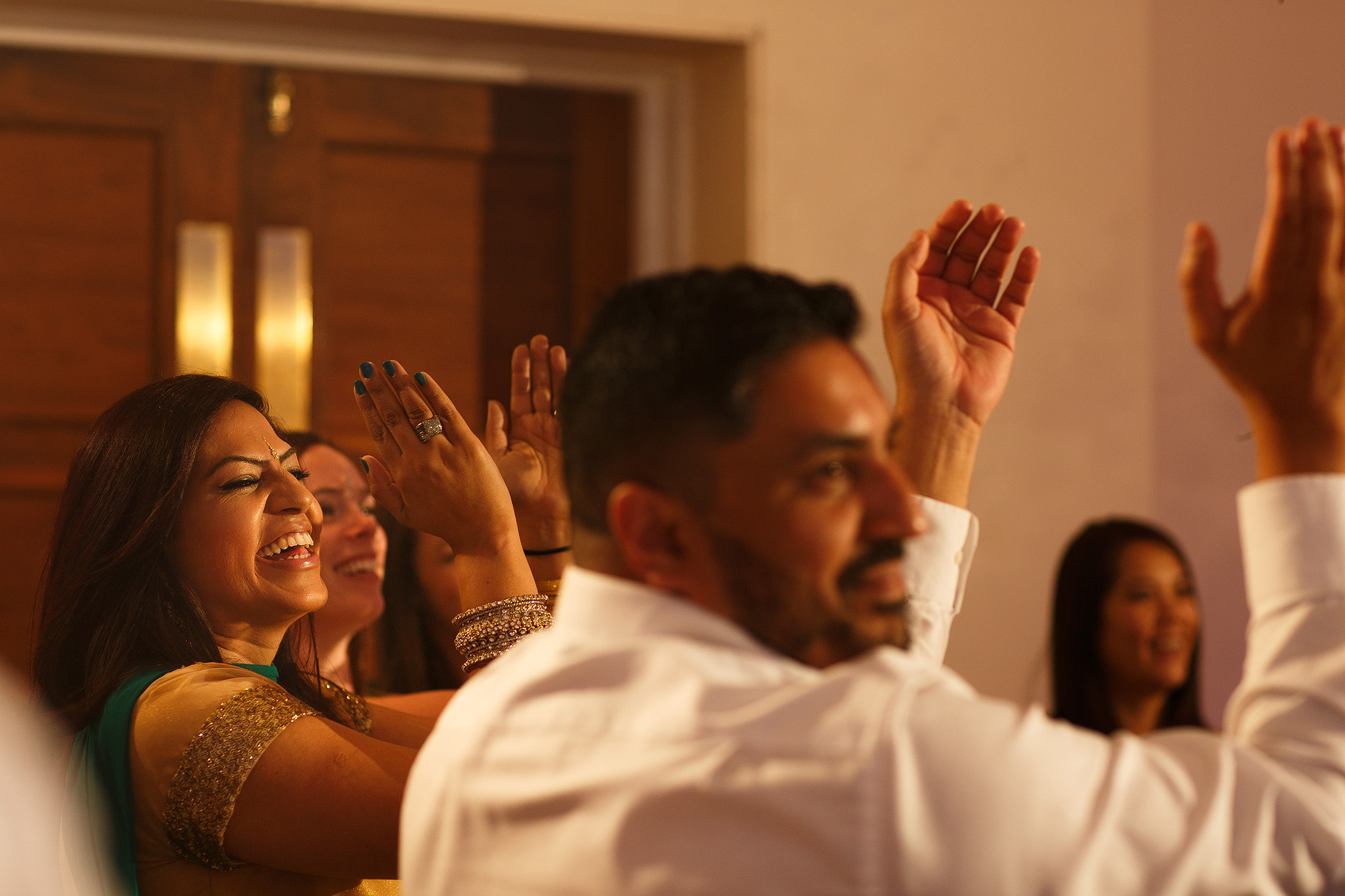Guests laughing during speeches at Indian wedding reception