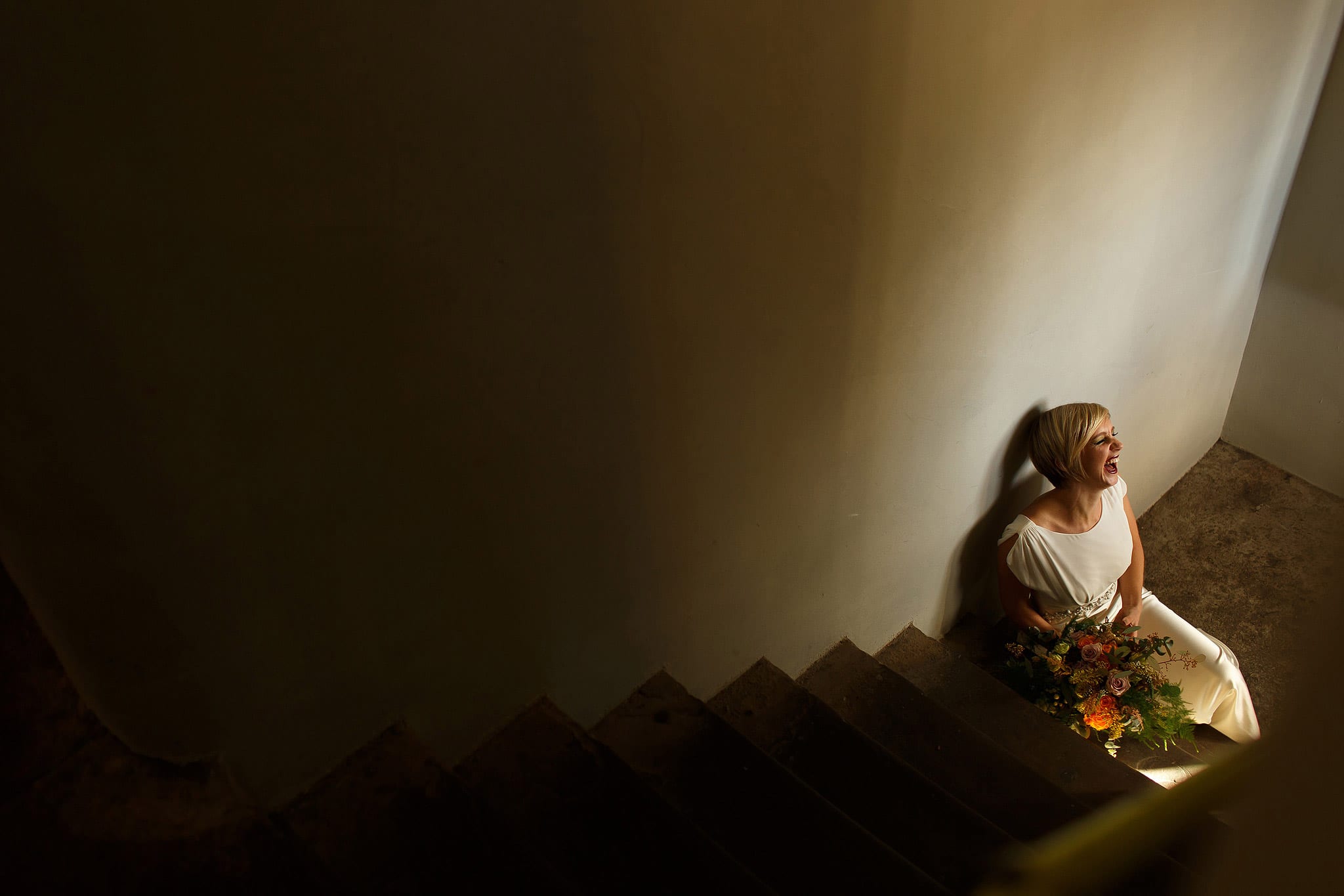 bride sat on staircase inside holmes mill