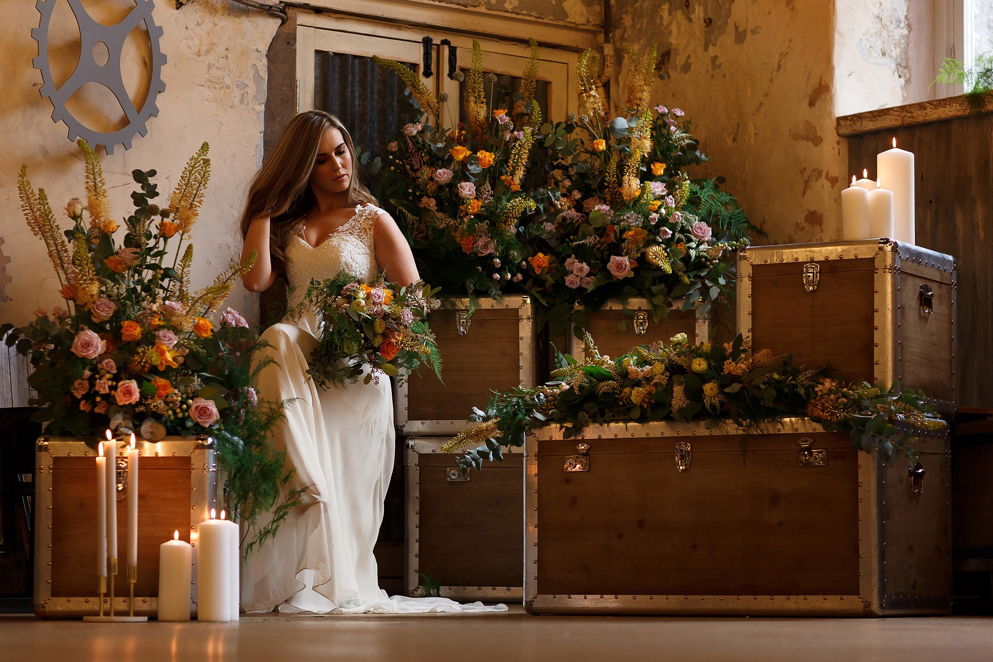 bride surrounded by flowers inside wedding reception at holmes mill
