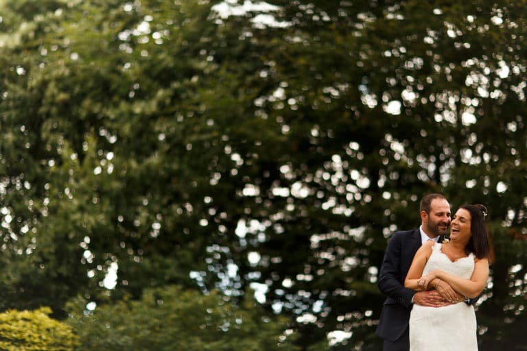 Wedding portrait of bride and groom with amazing bokeh in the gardens at Falcon Manor