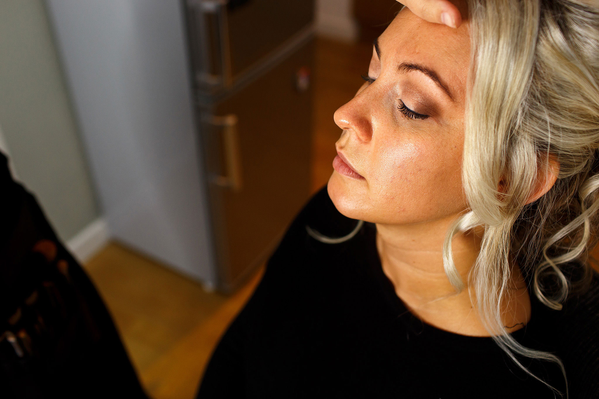 Bride having make up applied on the morning of the wedding