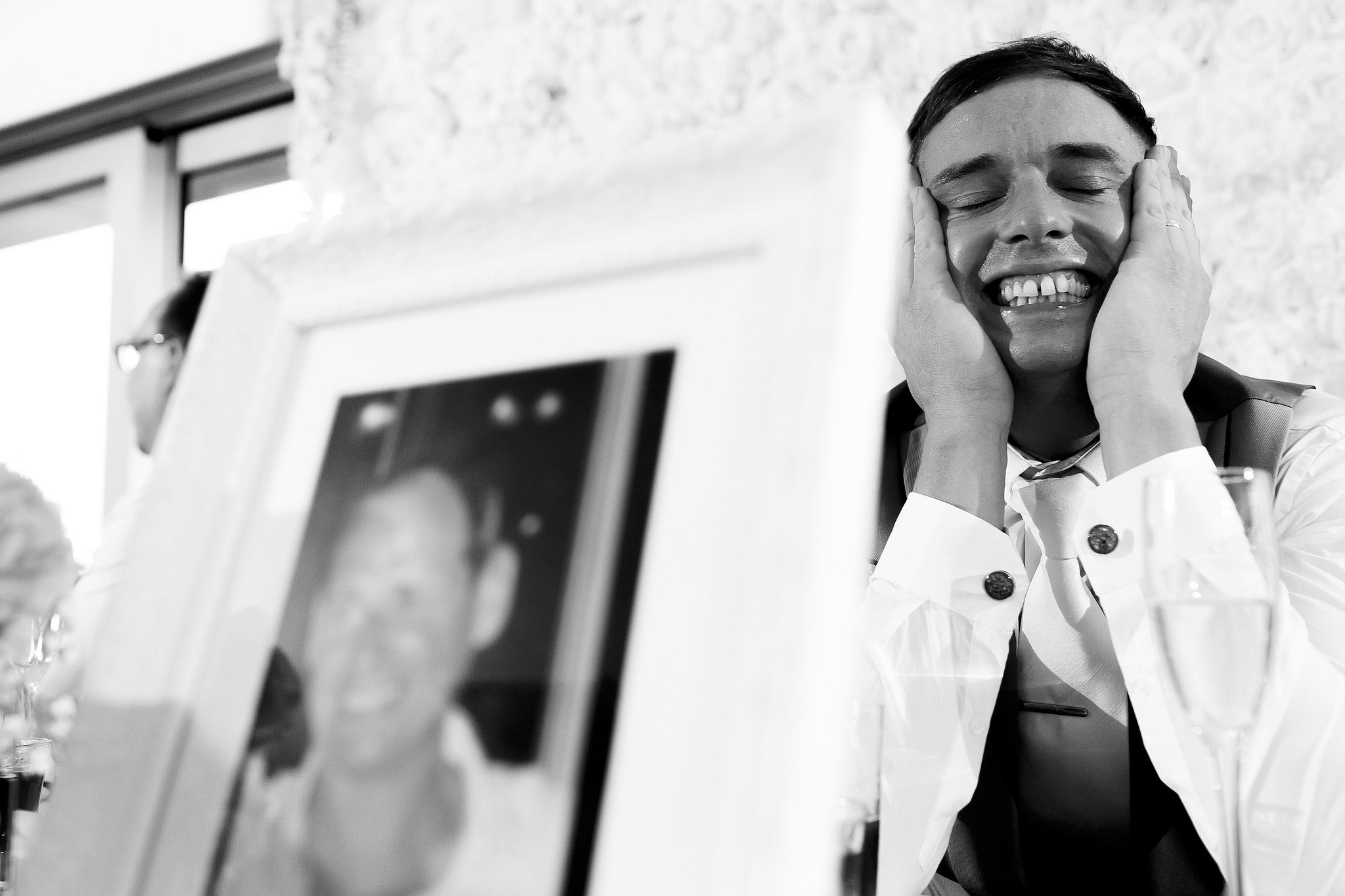 Groom holding his head in his hands during the speeches at Hurlston Hall wedding