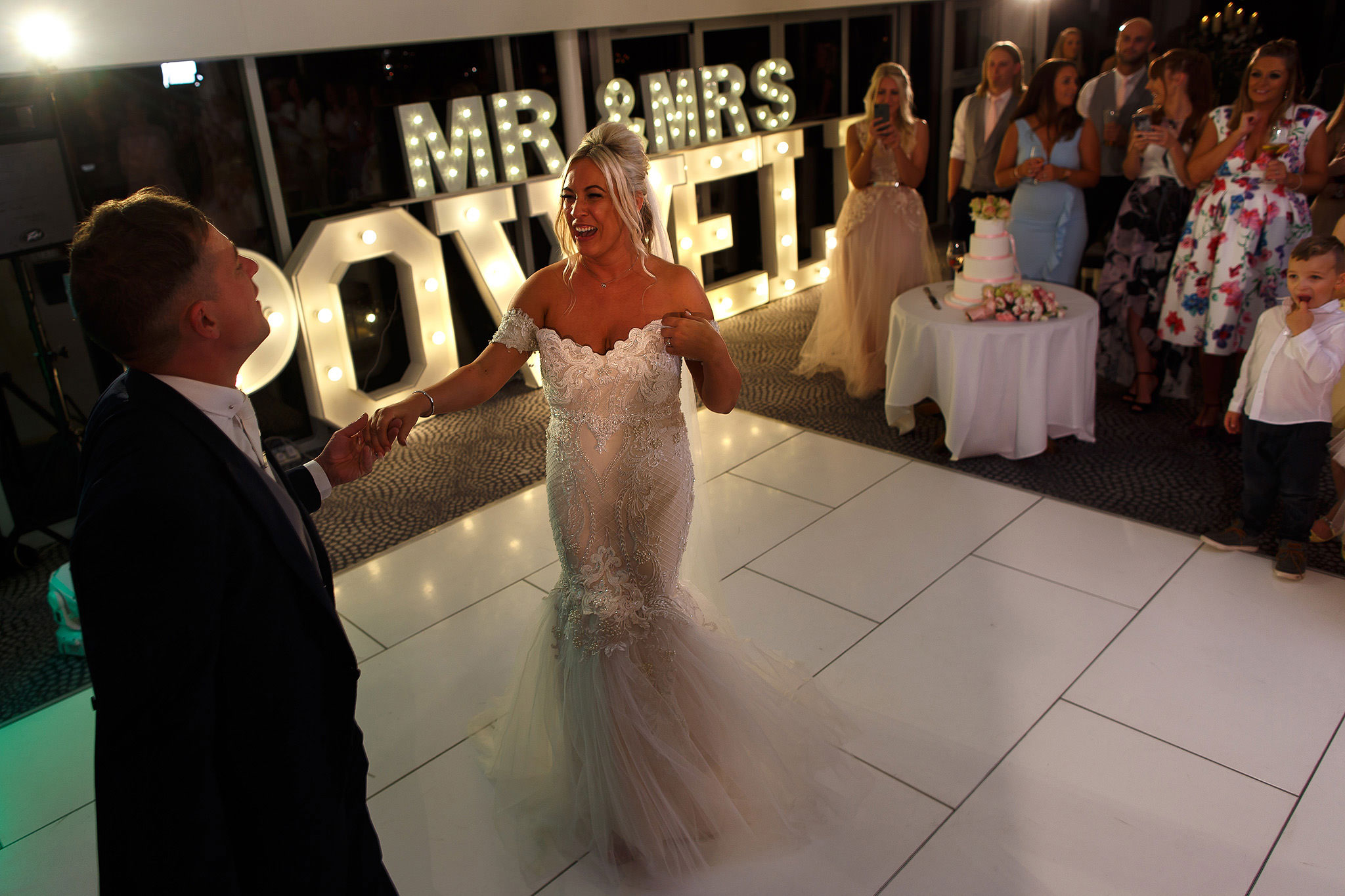 Bride and groom on the dance floor with light up letters behind them at Hurlston Hall wedding