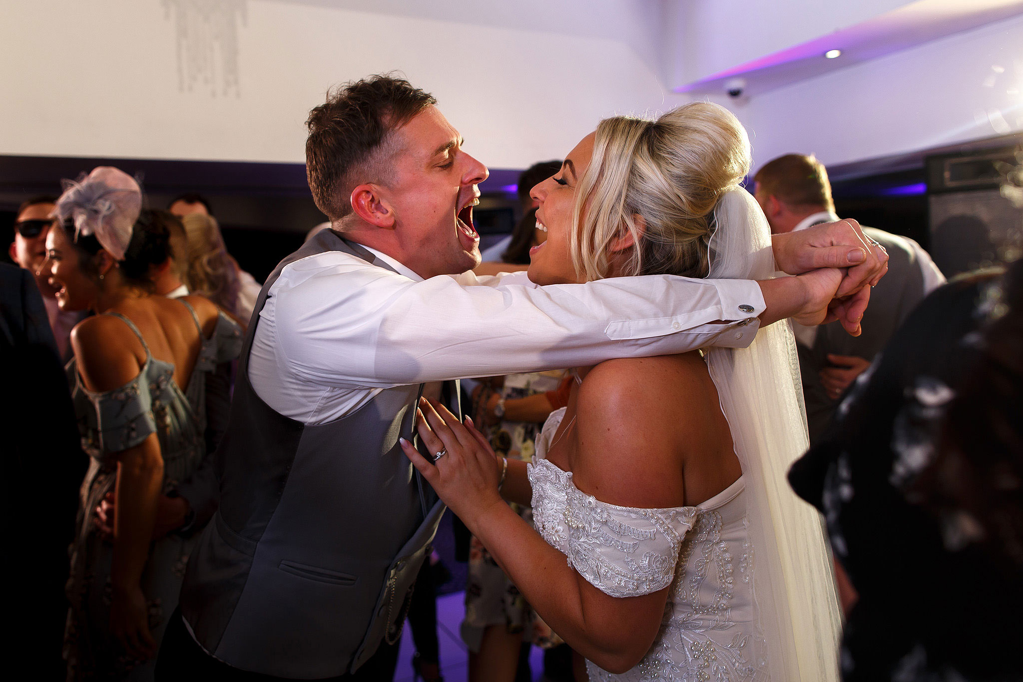 Bride and groom screaming into each others faces on the dance floor at Hurlston Hall Wedding