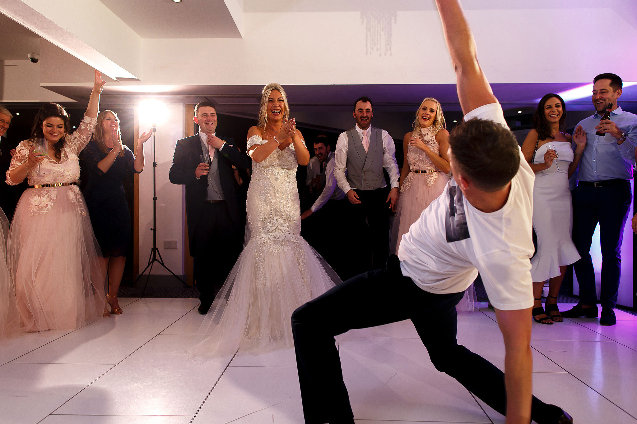 Groom break dancing on the dance floor at Hurlston Hall Wedding