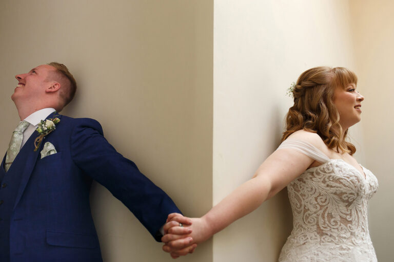 Bride and groom having a first touch before the wedding ceremony