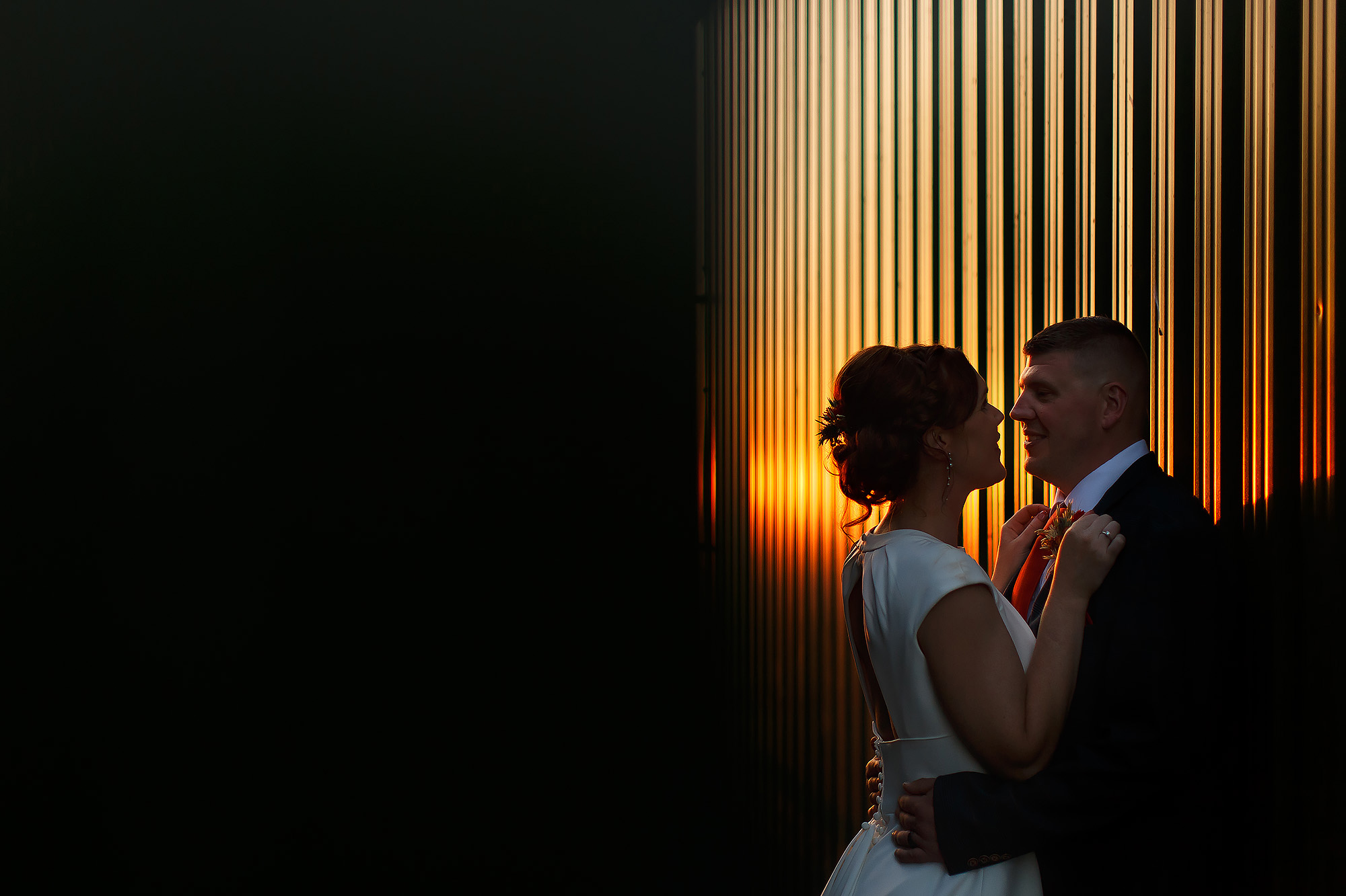 Bride and Groom facing close to one another during sunset by shipping container for industrial wedding photographs in Leeds City Centre